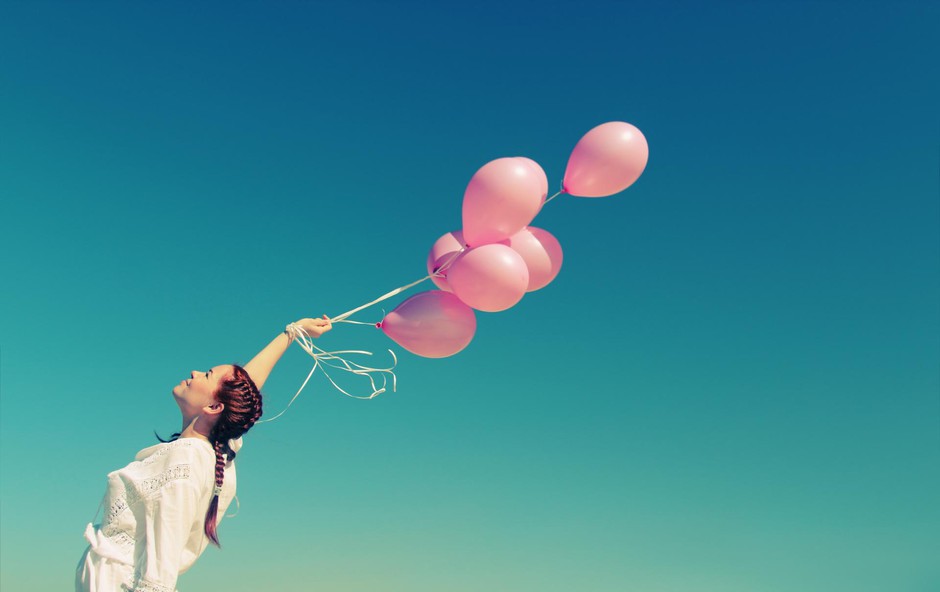 Young redhead woman holding pink balloons (foto: Foto: Shutterstock Shutterstock)