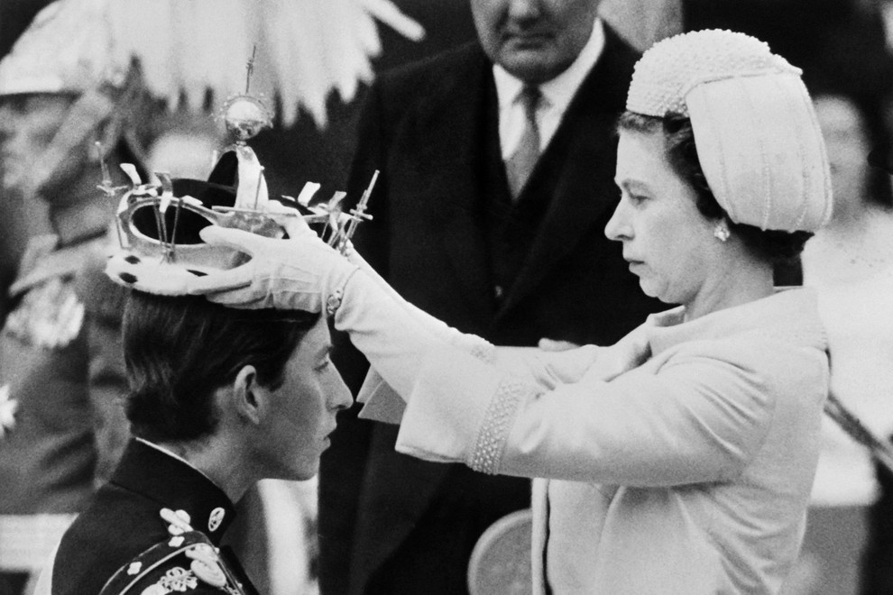 (FILES) In this file photo taken on July 01, 1969 Queen Elizabeth II puts a crown on his son Prince Charles during his investiture as new Prince of Wales in Caernarfon. Charles has spent virtually his entire life waiting to succeed his mother, Queen Elizabeth II, even as he took on more of her duties and responsibilities as she aged. But the late monarch's eldest son, 73, made the most of his record-breaking time as the longest-serving heir to the throne by forging his own path.,Image: 720746951, License: Rights-managed, Restrictions:, Model Release: no